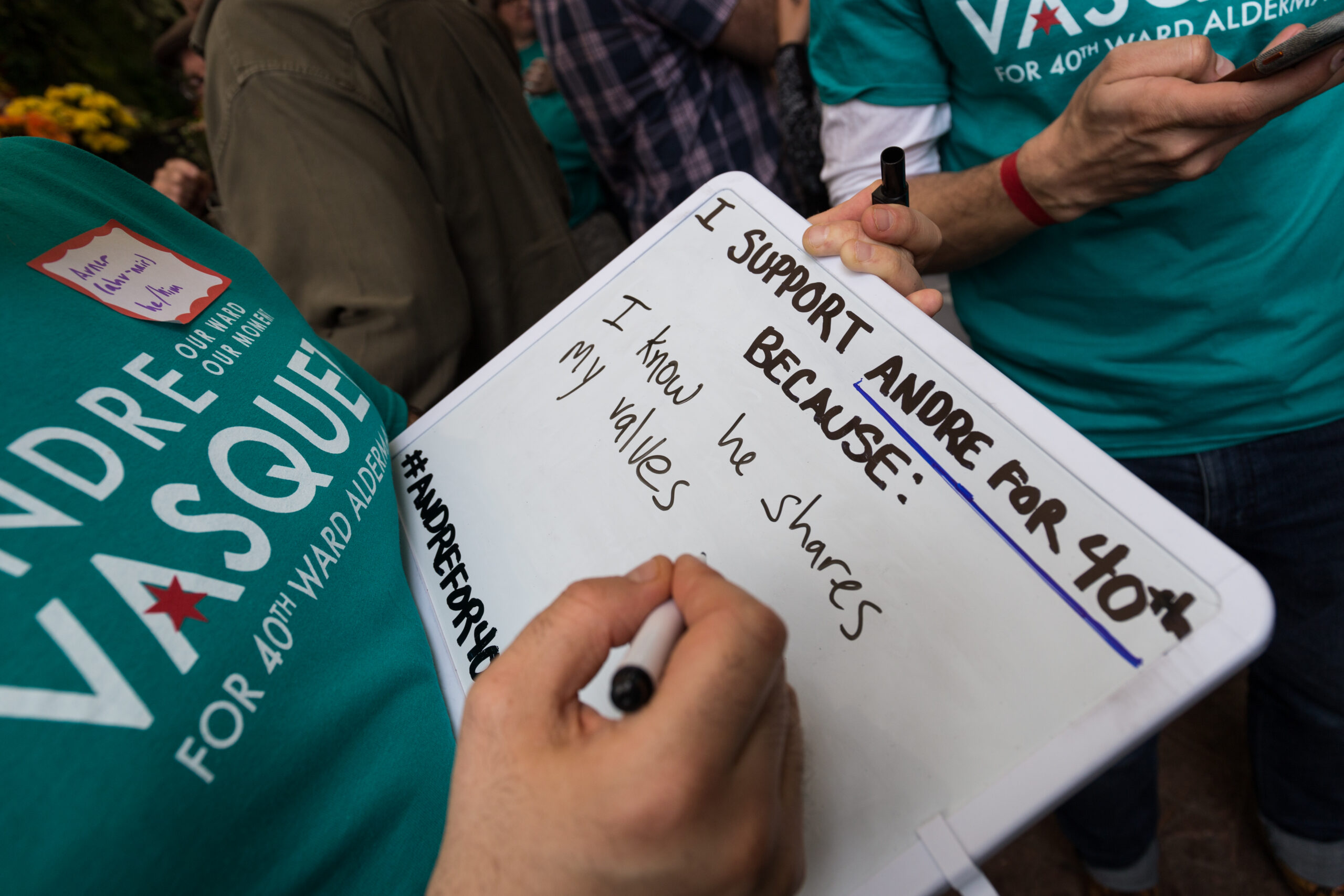 Close up of a person writing on a white board with the prompt “I support Andre for 40th because..”