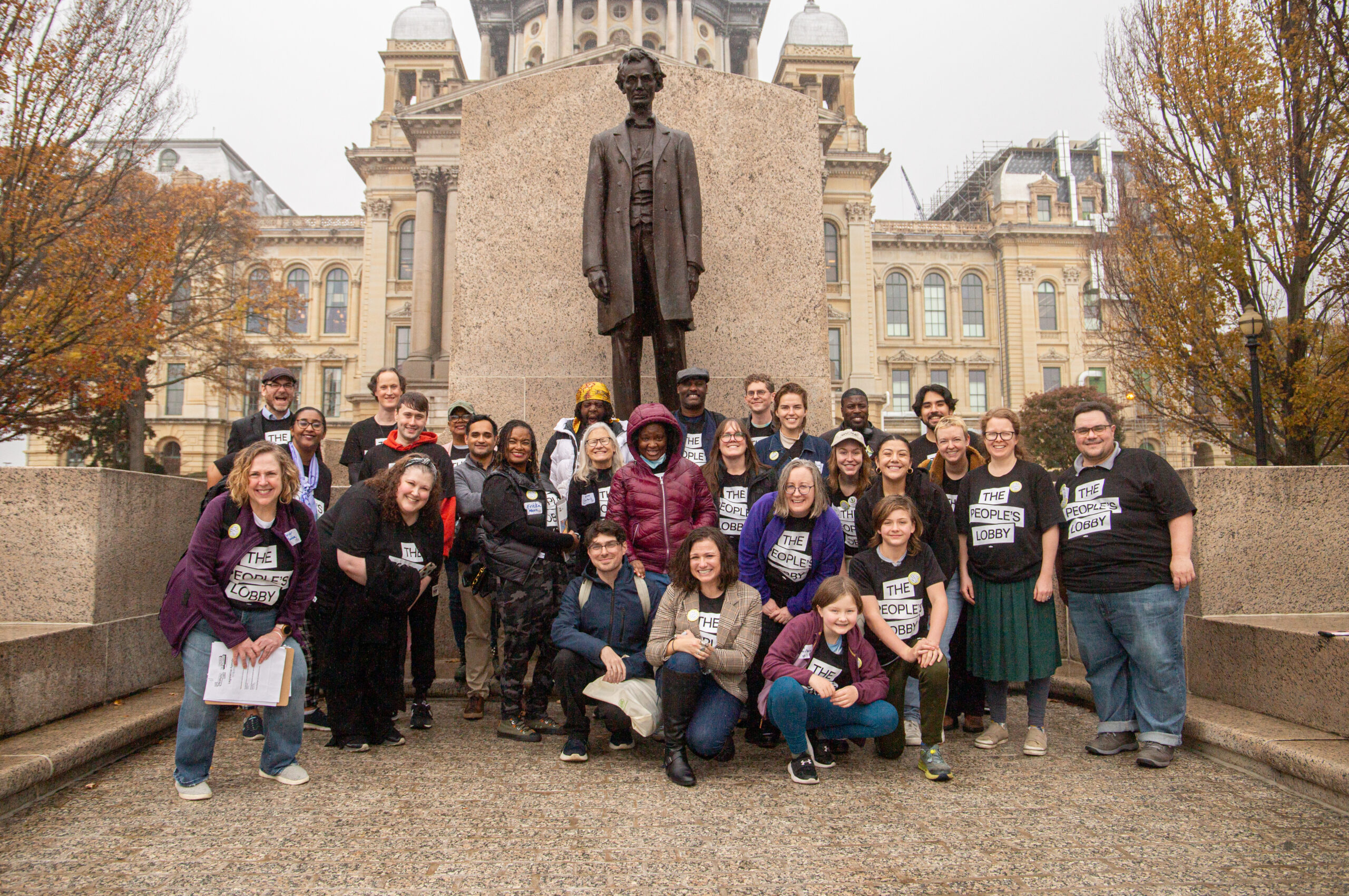 Our crew smiling in front of the statute of Abraham Lincoln at the Capitol.